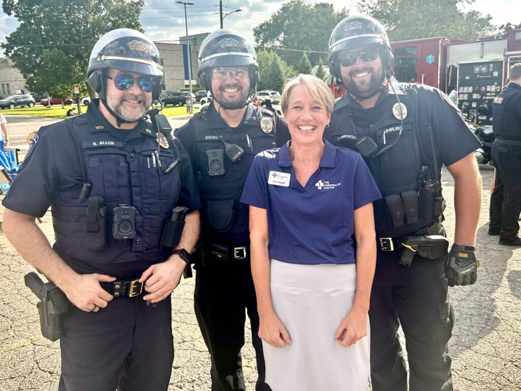 Lettie of The Chiropractic Doctor with Wyoming Police officers at a community event