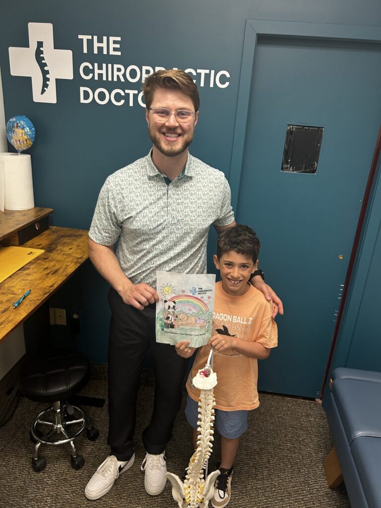 Dr. Parker Bowen with a young patient at The Chiropractic Doctor in Wyoming, MI